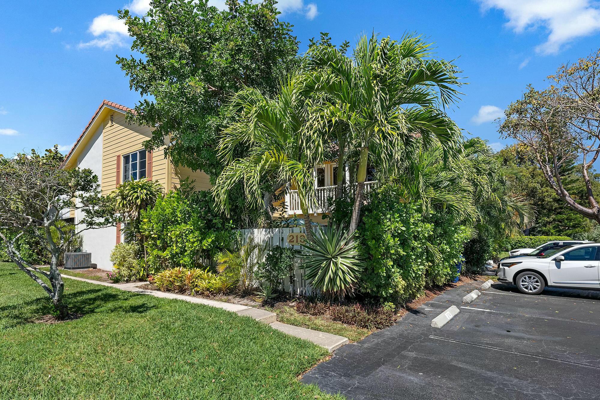 213 Seabreeze Circle Jupiter, FL 33477 - Photo 22 of 38 a view of a car parked in front of a house with a street