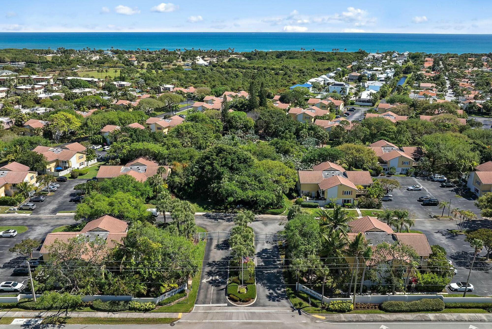 213 Seabreeze Circle Jupiter, FL 33477 - Photo 27 of 38 an aerial view of residential houses with outdoor space and trees