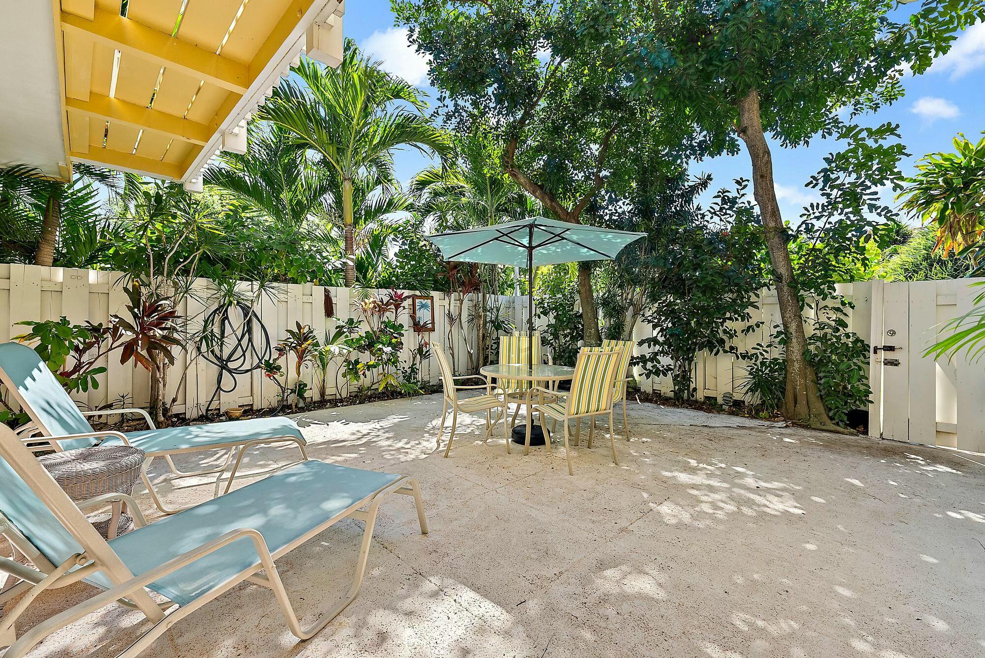 213 Seabreeze Circle Jupiter, FL 33477 - Photo 3 of 38 an outdoor space with patio and white umbrellas