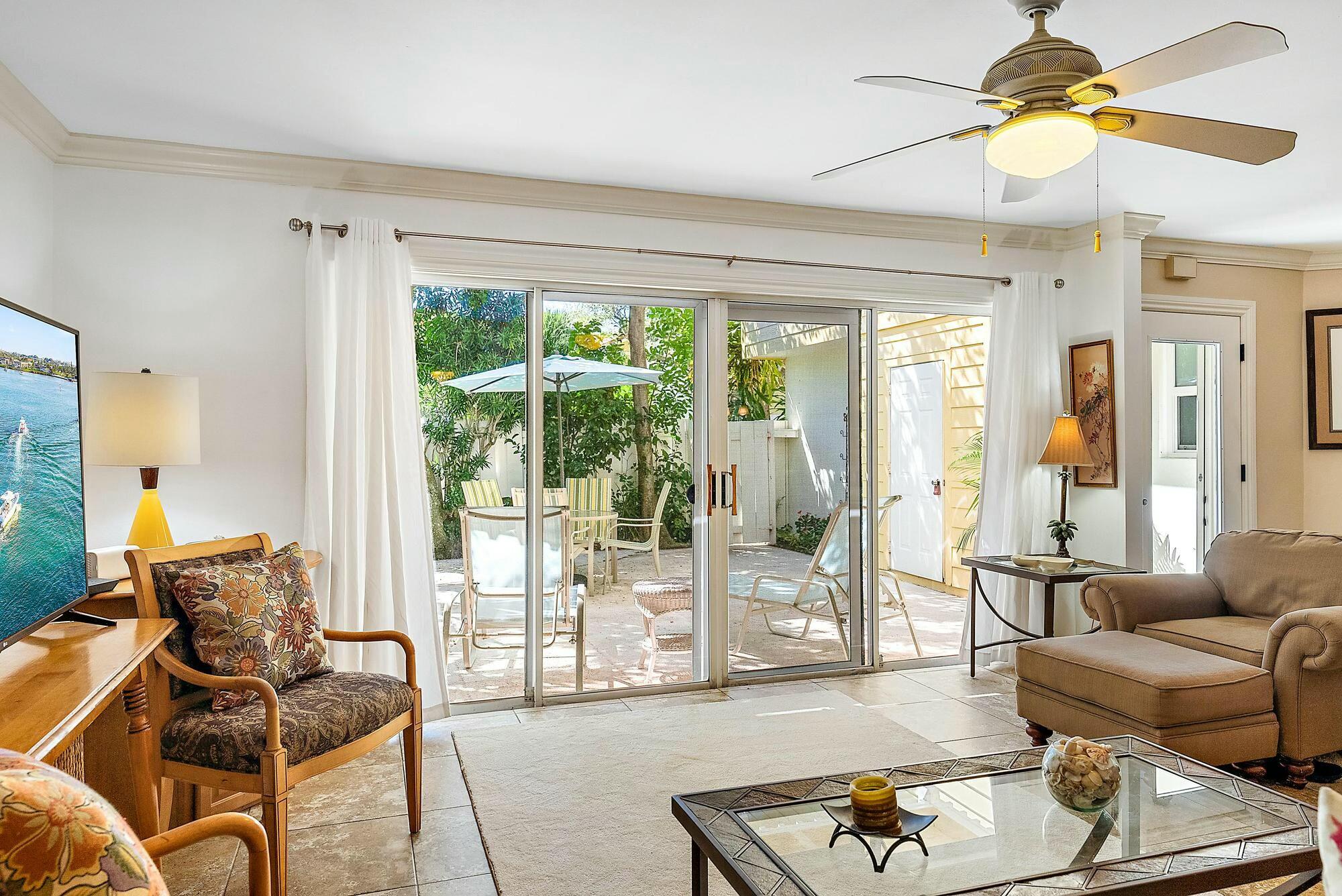 213 Seabreeze Circle Jupiter, FL 33477 - Photo 5 of 38 a living room with furniture and a large window