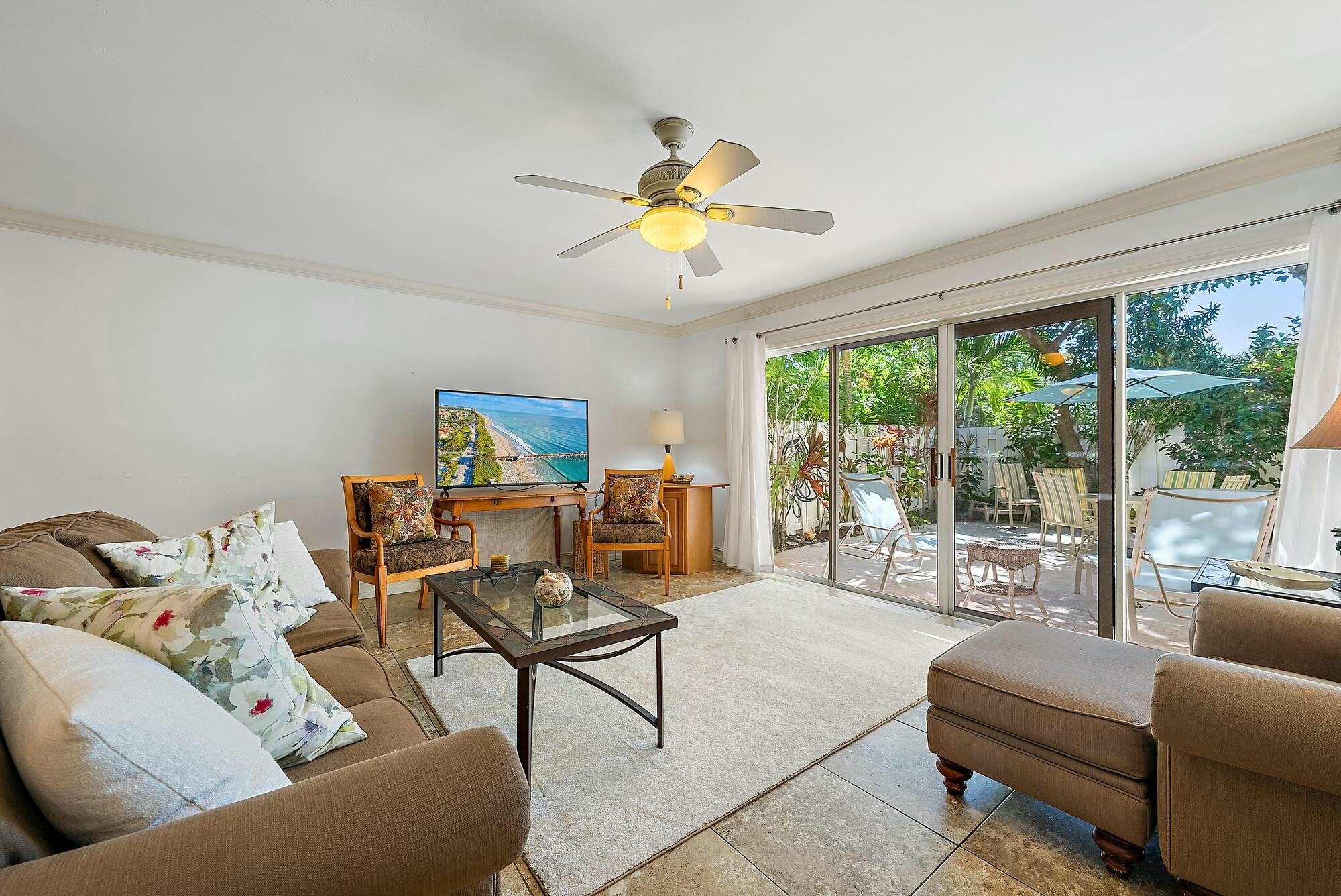 213 Seabreeze Circle Jupiter, FL 33477 - Photo 7 of 38 a living room with furniture and a chandelier