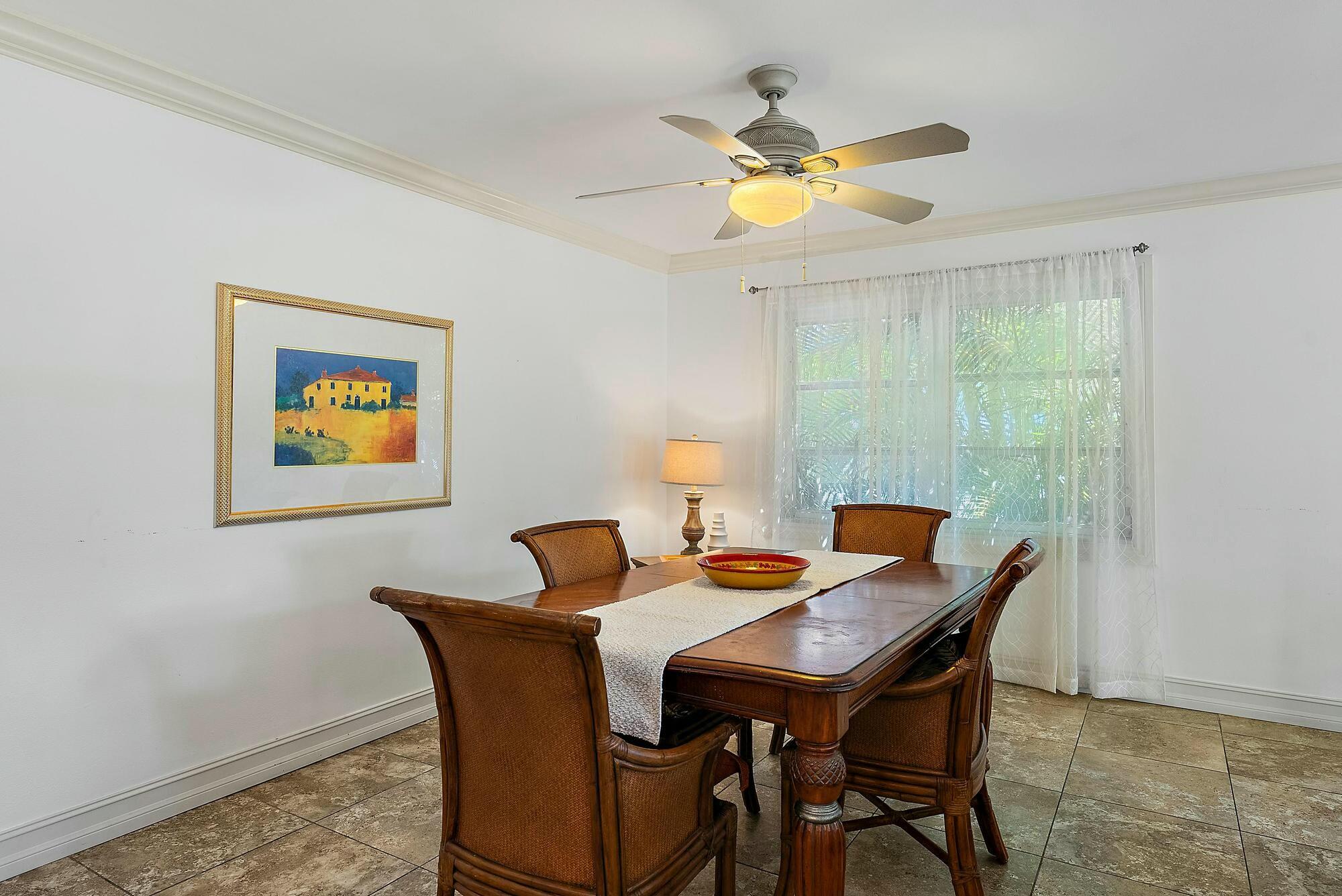 213 Seabreeze Circle Jupiter, FL 33477 - Photo 8 of 38 a view of a dining room with a table and chairs