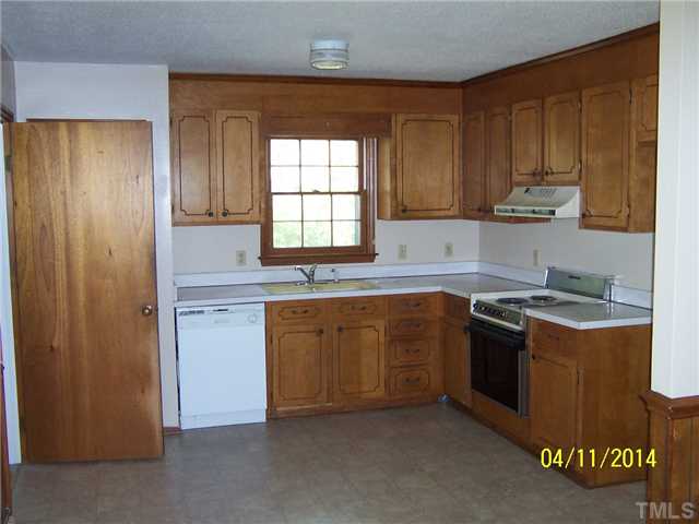 2905 Rannock Court Raleigh, NC 27604 - Photo 4 of 8 a kitchen with stainless steel appliances granite countertop a stove a sink and a refrigerator