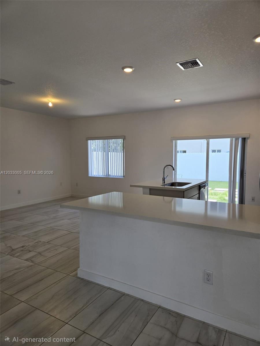 862 Southeast 17 Street, Unit 862 Homestead, FL 33034 - Photo 20 of 39 a large white kitchen with cabinets and a wooden floor