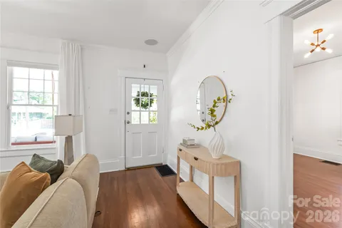 a bedroom with furniture and a wooden floor