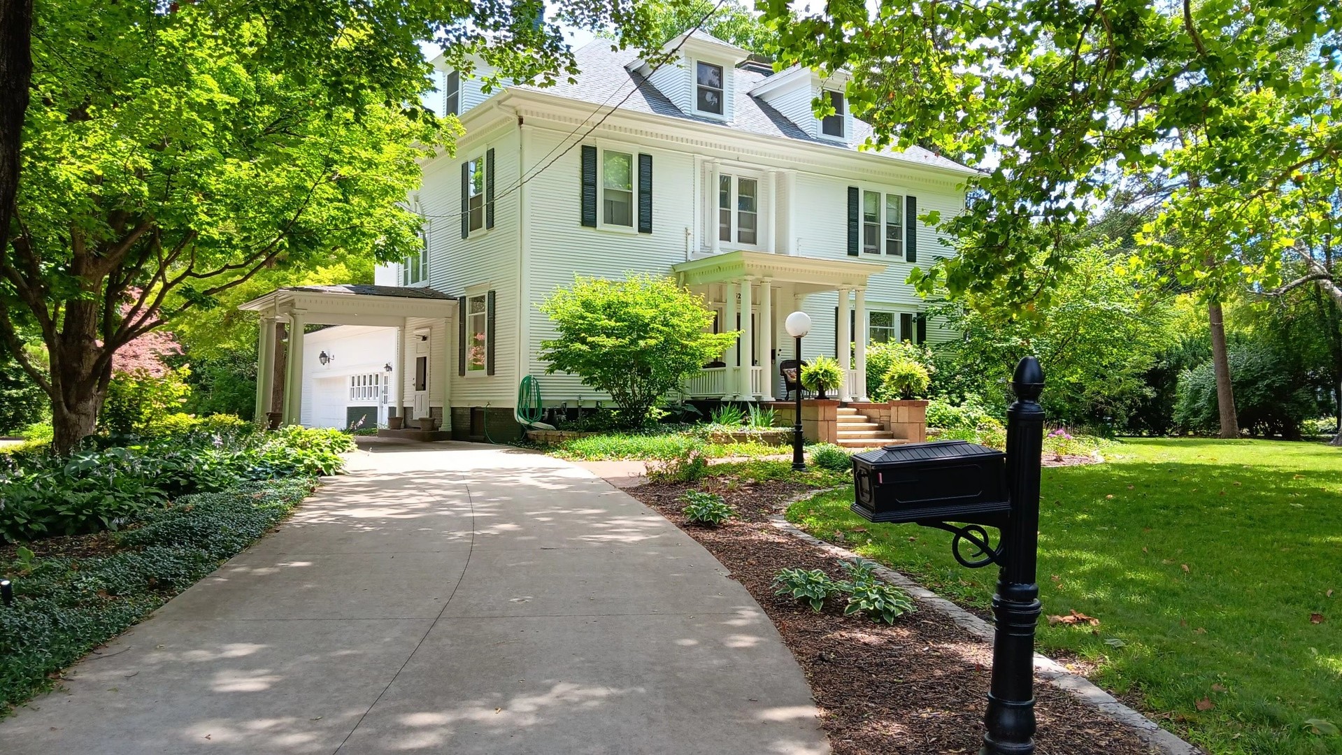 1325 South Main Street Princeton, IL 61356 - Photo 1 of 29 a front view of a house with a yard and a garden