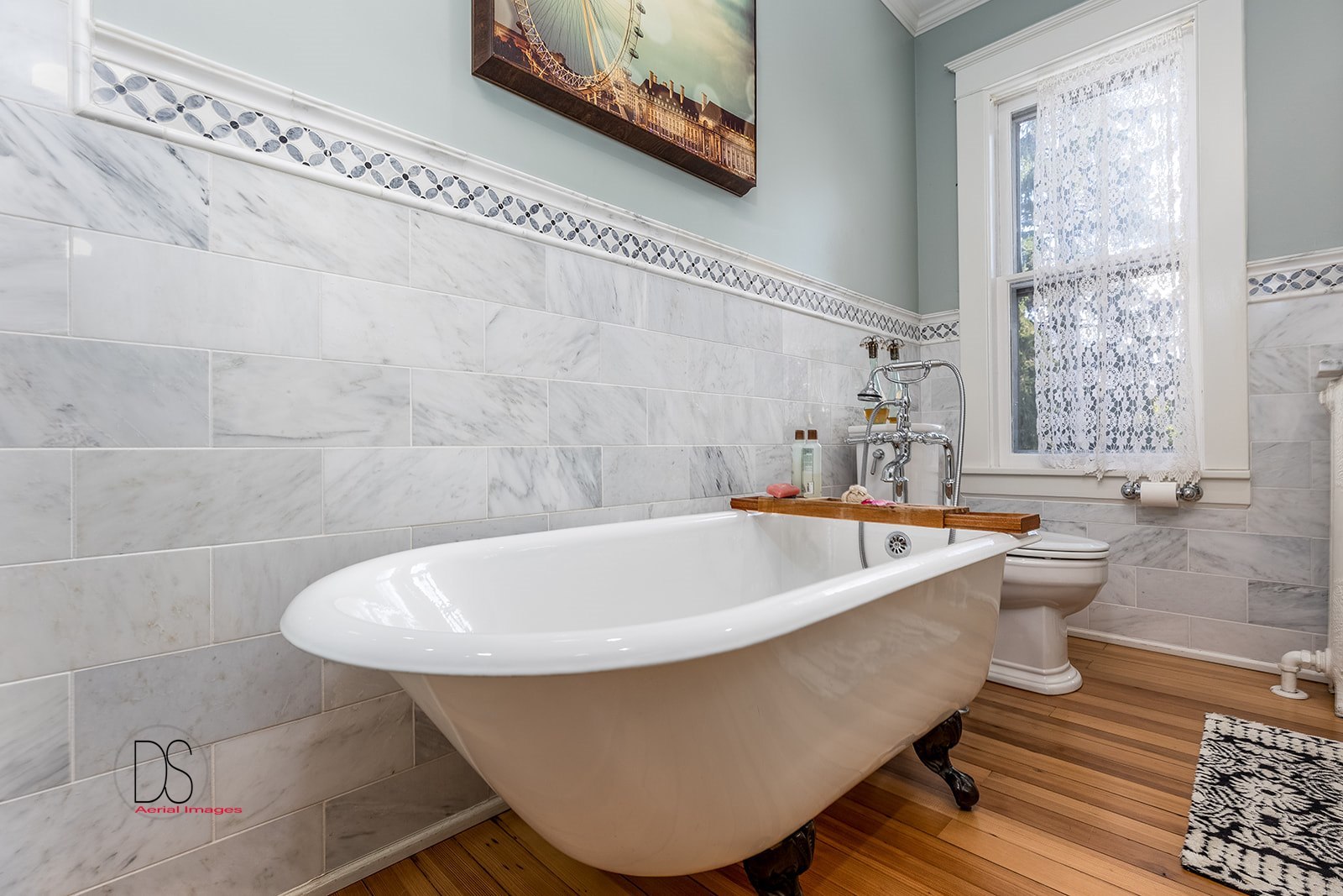 1325 South Main Street Princeton, IL 61356 - Photo 12 of 29 a bathroom with a white tub a sink and a window