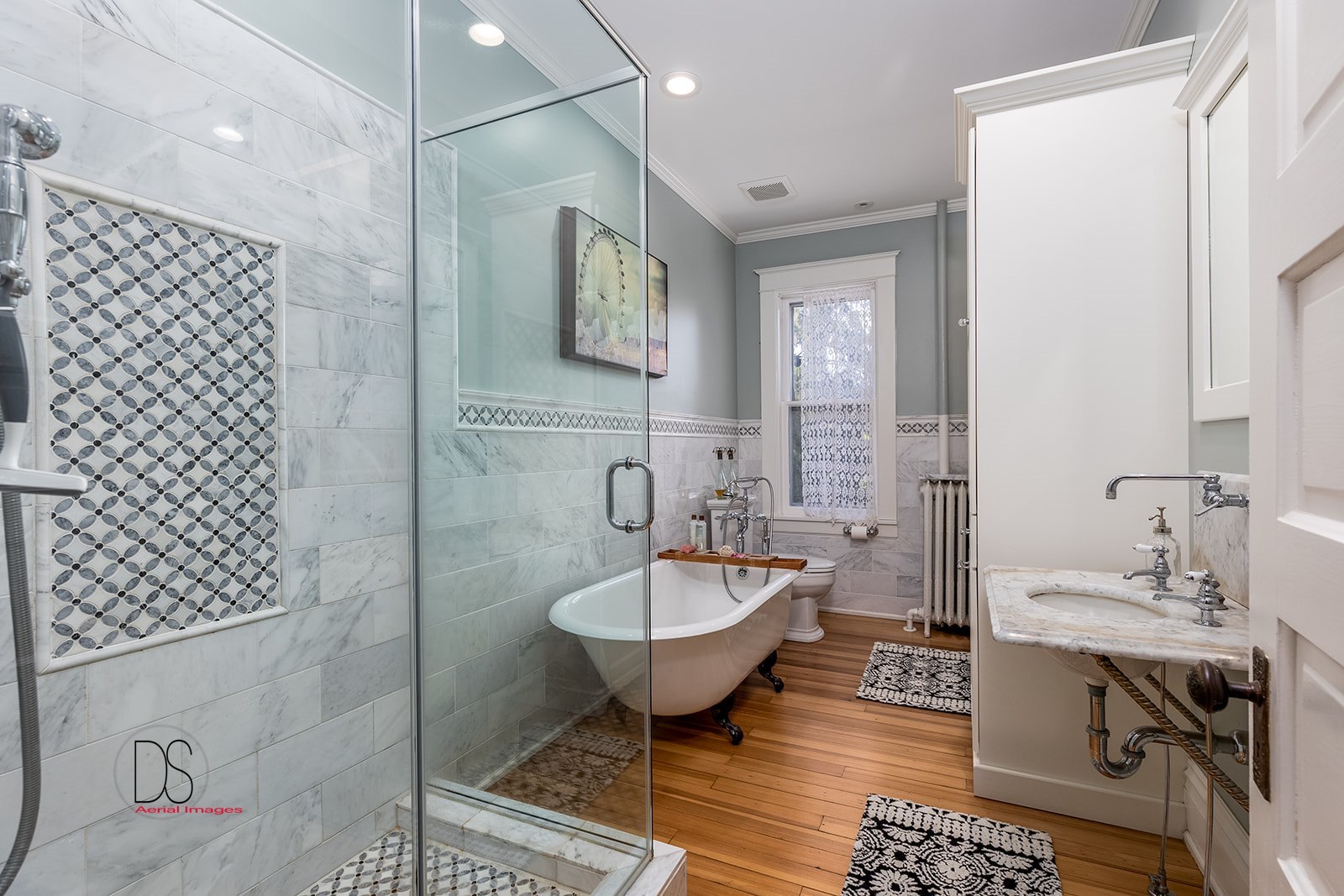 1325 South Main Street Princeton, IL 61356 - Photo 8 of 29 a bathroom with a sink a mirror a toilet and a shower