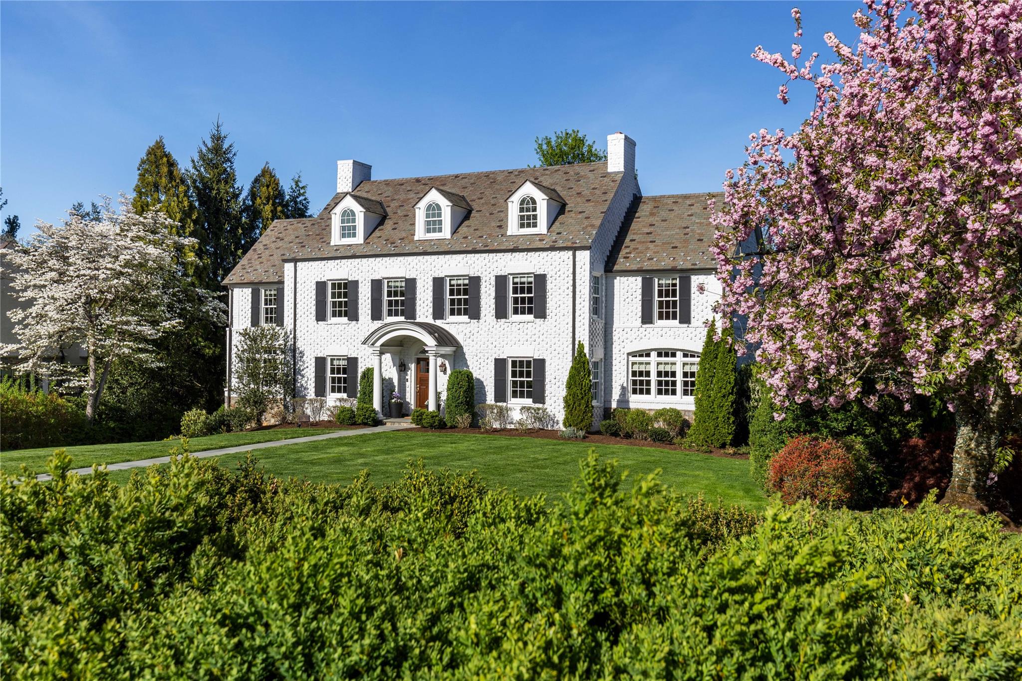 a front view of a house with a garden