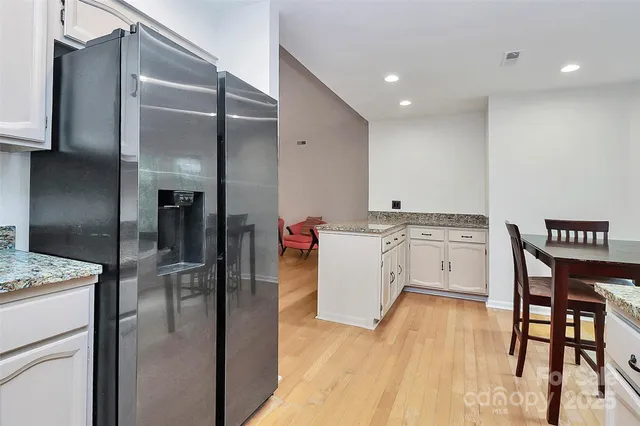 a kitchen with a sink appliances and cabinets