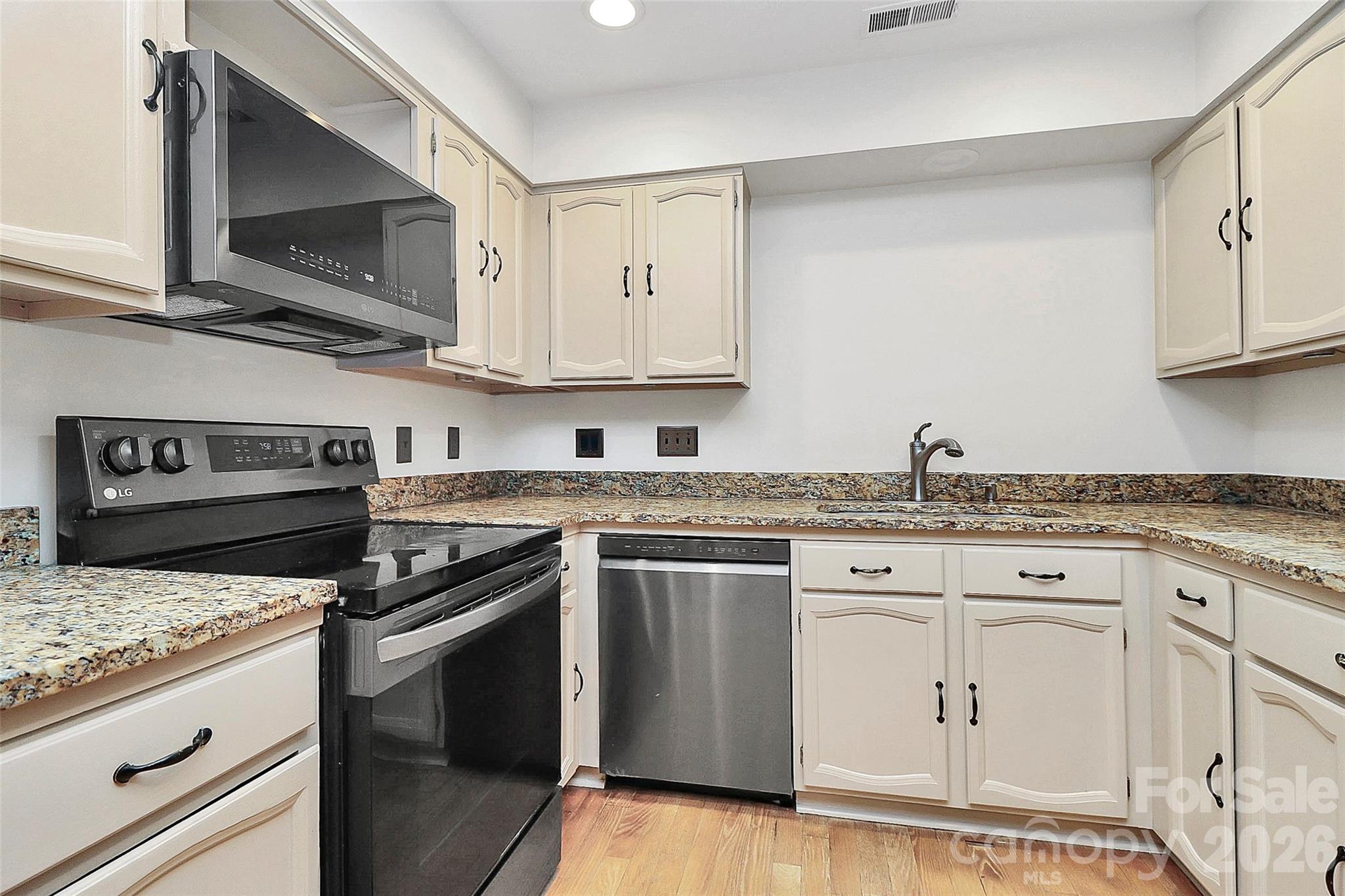 16 Woodvine Lane Clover, SC 29710 - Photo 12 of 48 a kitchen with stainless steel appliances granite countertop a stove and a microwave