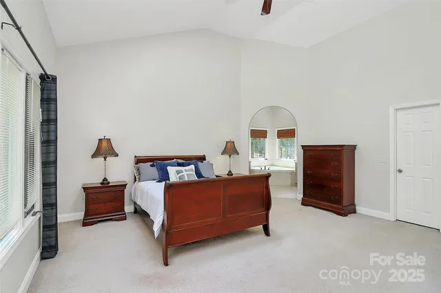 a bed room with a bed and a chair