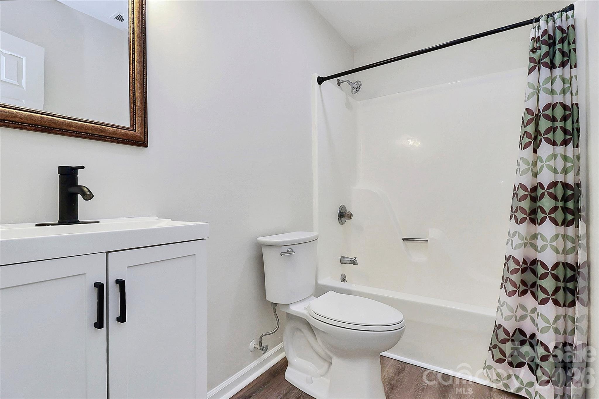 16 Woodvine Lane Clover, SC 29710 - Photo 19 of 48 a bathroom with a sink a toilet and shower curtain