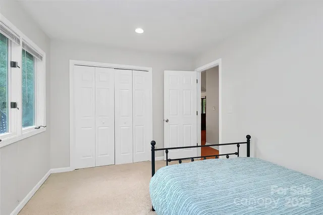 a bedroom with a bed and a tv