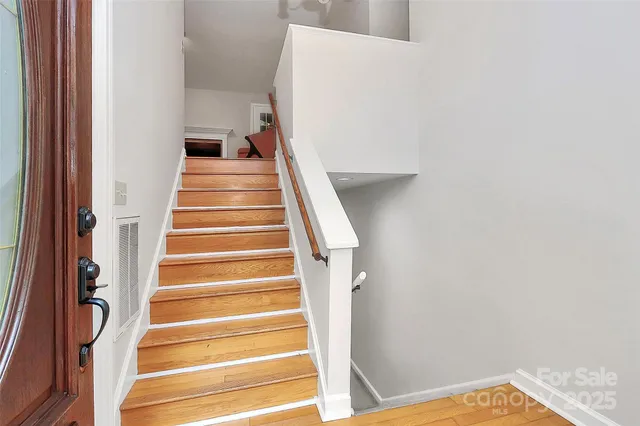 an empty room with fireplace and a ceiling fan
