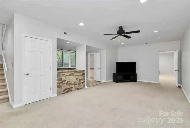 a view of a livingroom with furniture and a flat screen tv