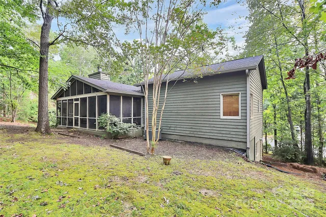 a view of a backyard with a garden and trees