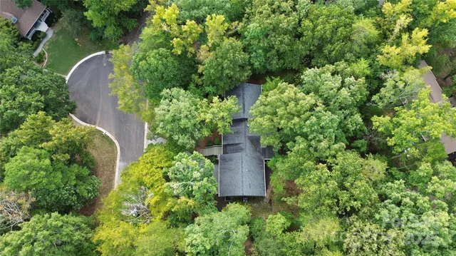 an aerial view of a house with a yard and garden