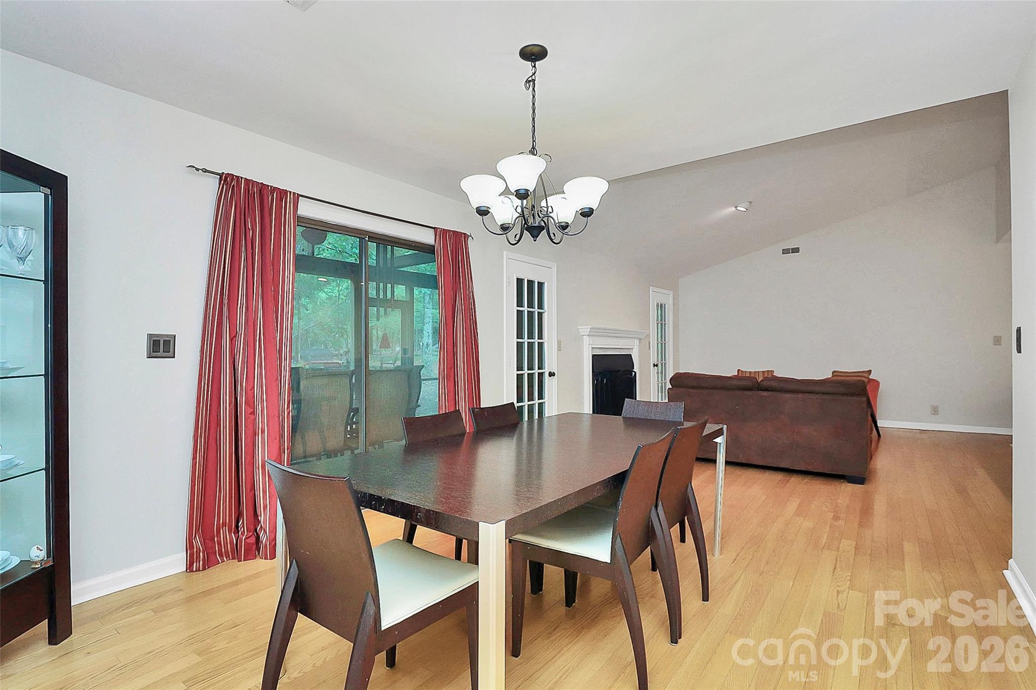 16 Woodvine Lane Clover, SC 29710 - Photo 10 of 48 a dining room with wooden floor a chandelier a wooden table and chairs