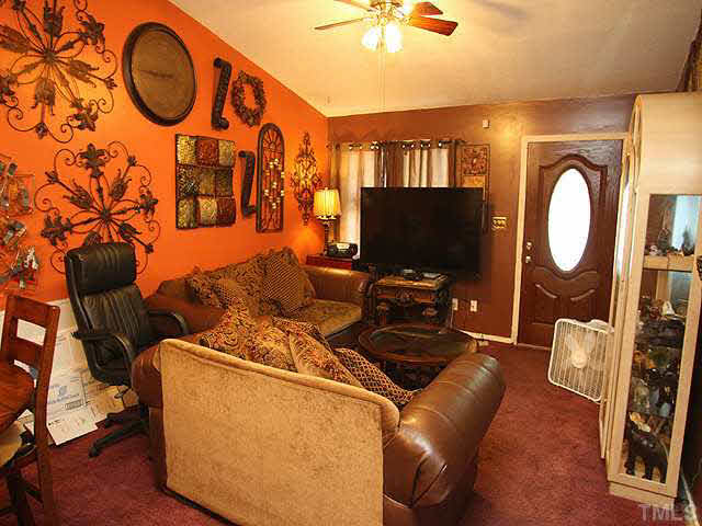 404 Top Greene Lane Raleigh, NC 27601 - Photo 3 of 11 a living room with furniture a flat screen tv and a large window