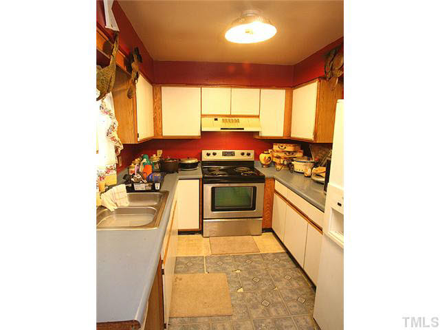 404 Top Greene Lane Raleigh, NC 27601 - Photo 6 of 11 a kitchen with stainless steel appliances a stove a sink and a microwave