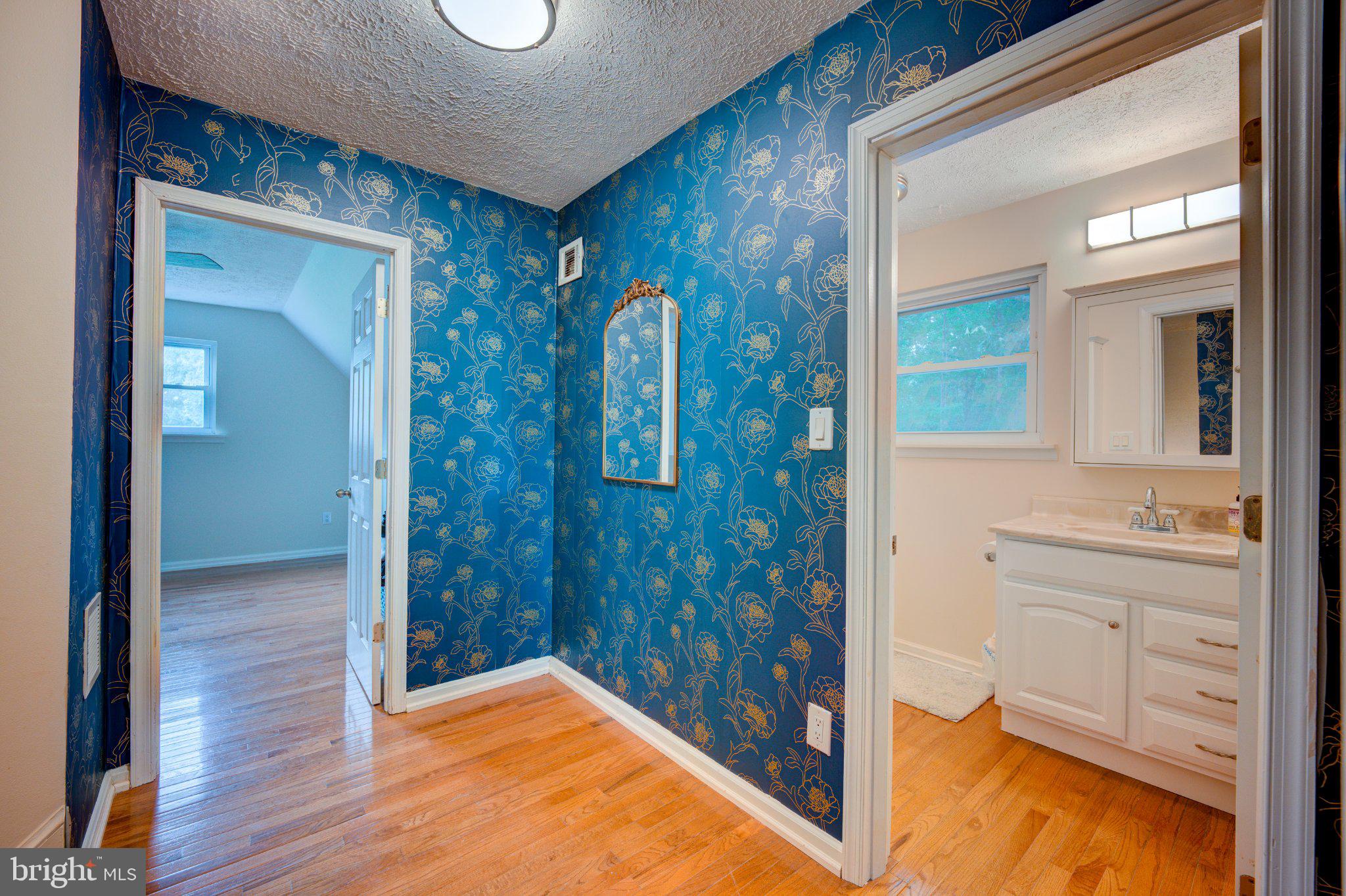 9595 Roys Lane Culpeper, VA 22701 - Photo 29 of 61 Charming hallway with vibrant wallpaper.