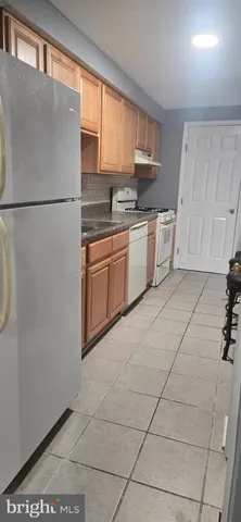 a kitchen with stainless steel appliances granite countertop a refrigerator sink and cabinets