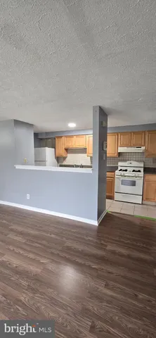 a view of kitchen and wooden floor