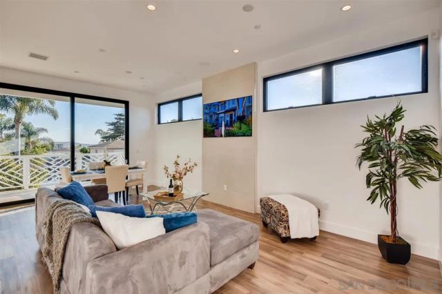 a view of a dining room with furniture large windows and wooden floor