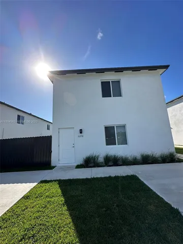 a house with garden in front of it