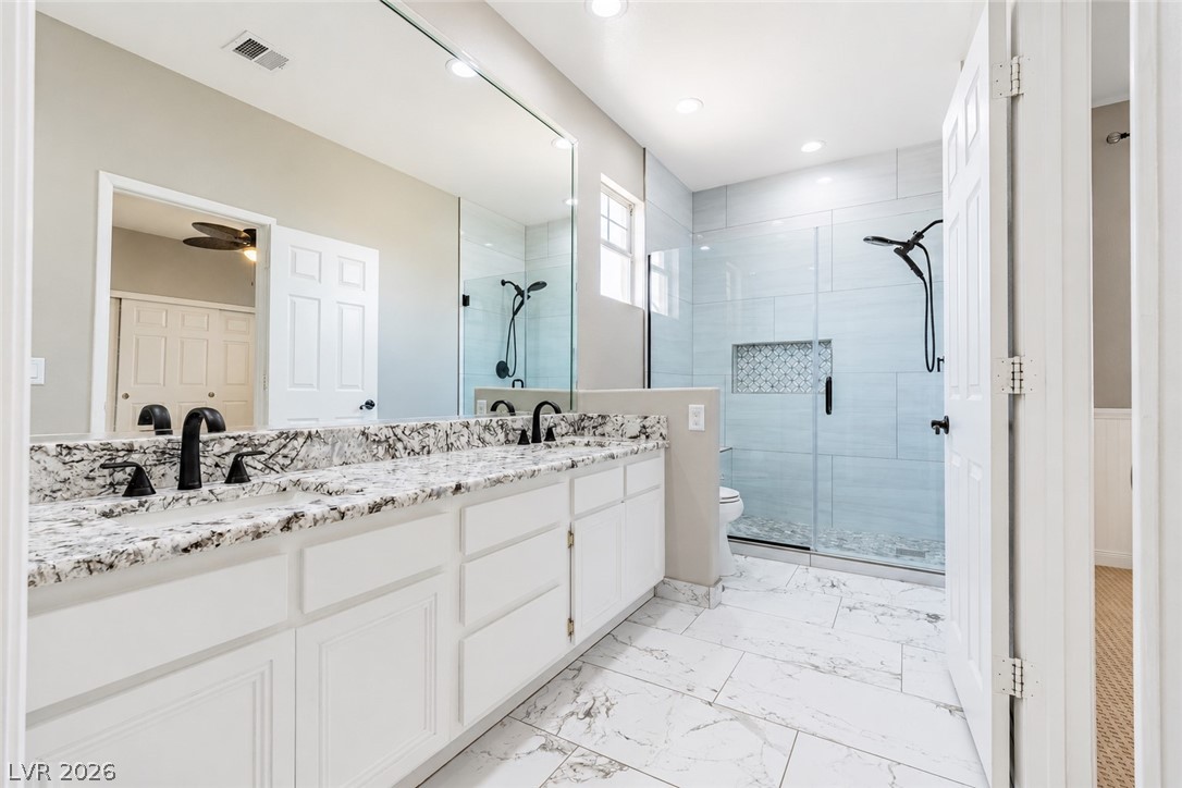 2504 Putting Green Drive Henderson, NV 89074 - Photo 31 of 56 This bathroom features a double vanity with ample counter space and a spacious walk-in shower.