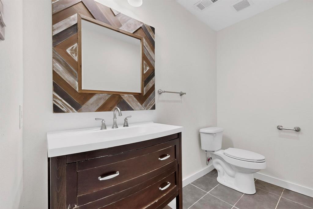 2519 Maverick Avenue Dallas, TX 75228 - Photo 11 of 31 a bathroom with a toilet a sink and mirror