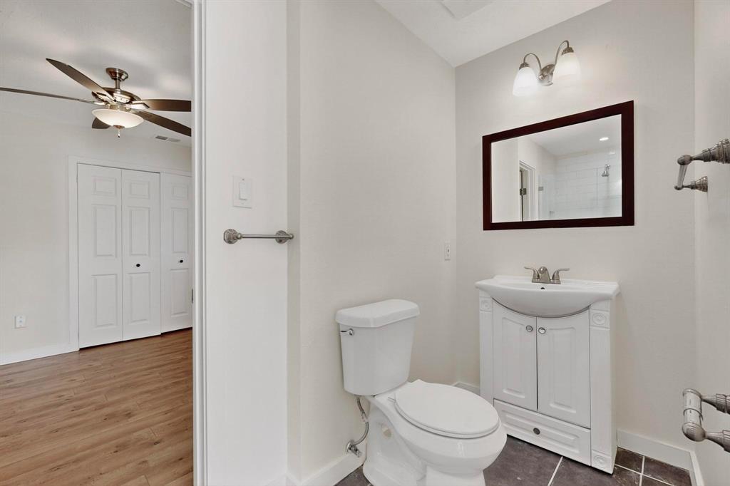 2519 Maverick Avenue Dallas, TX 75228 - Photo 20 of 31 a bathroom with a toilet a sink and mirror