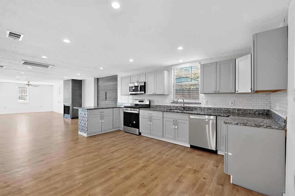 2519 Maverick Avenue Dallas, TX 75228 - Photo 8 of 31 a large kitchen with granite countertop a large counter top stainless steel appliances and cabinets