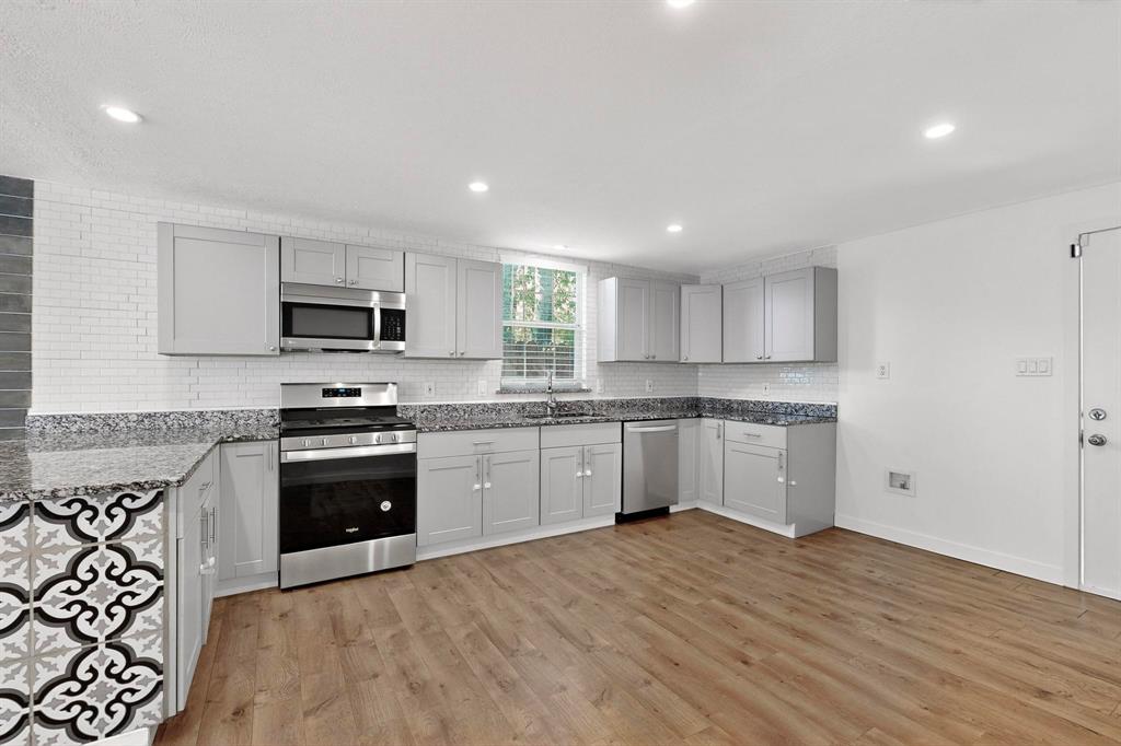 2519 Maverick Avenue Dallas, TX 75228 - Photo 9 of 31 a kitchen with granite countertop white cabinets and stainless steel appliances