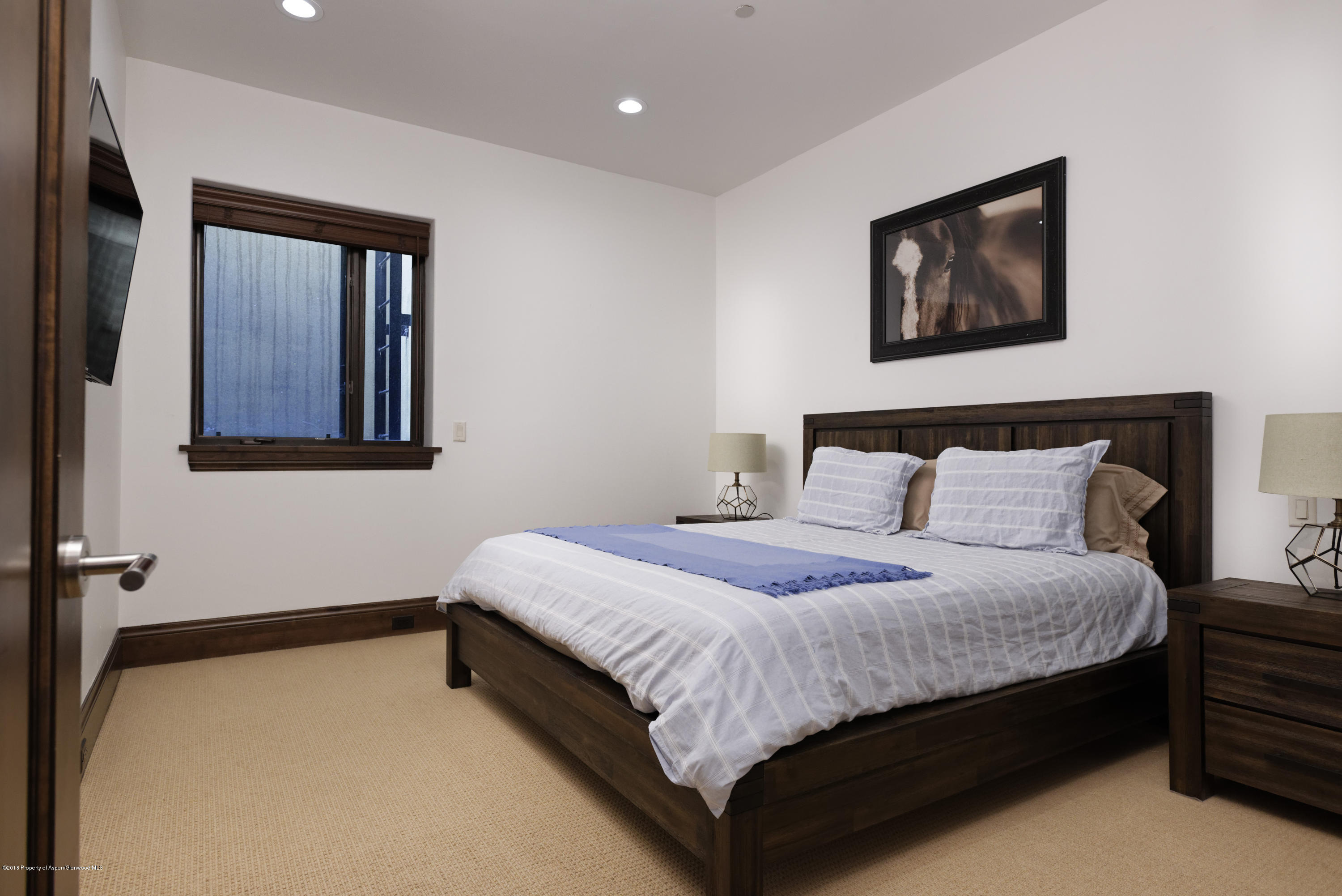 566 Race Street Aspen, CO 81611 - Photo 13 of 21 a bedroom with a bed and wall painting