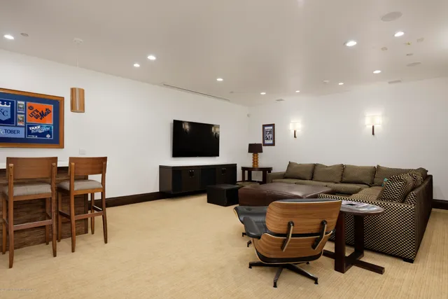 a view of a white house next to a road with a building in the background