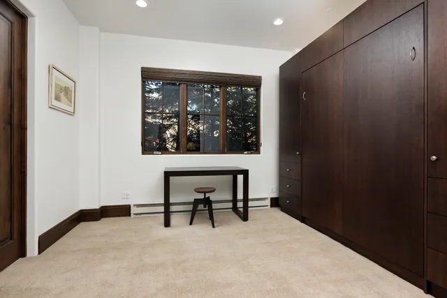 a bedroom with a bed and glass window