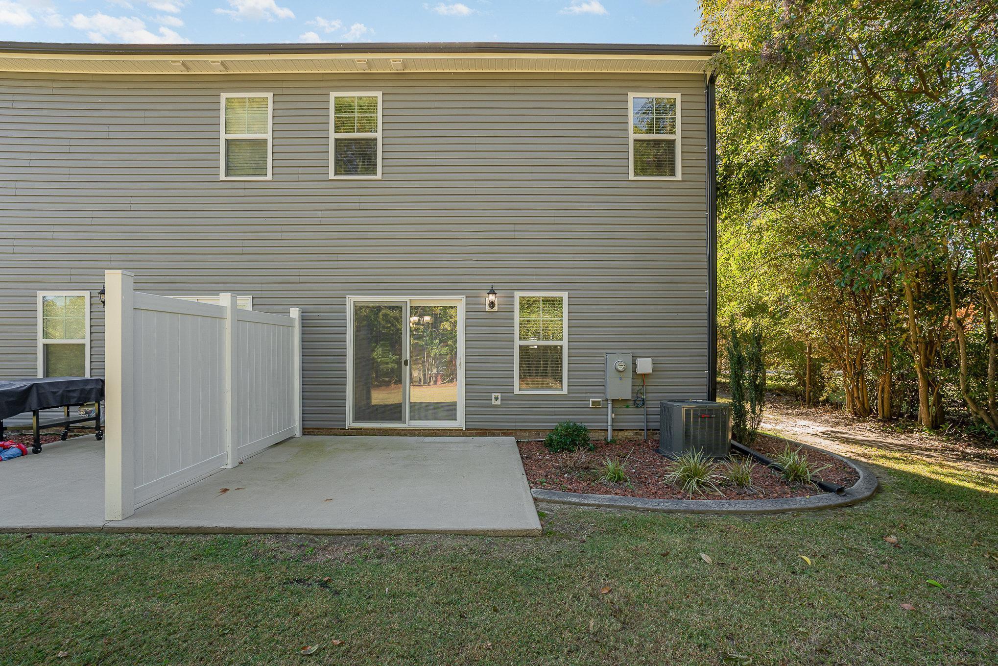407 East 3rd Street Princeton, NC 27569 - Photo 16 of 18 a front view of a house with a yard and potted plants