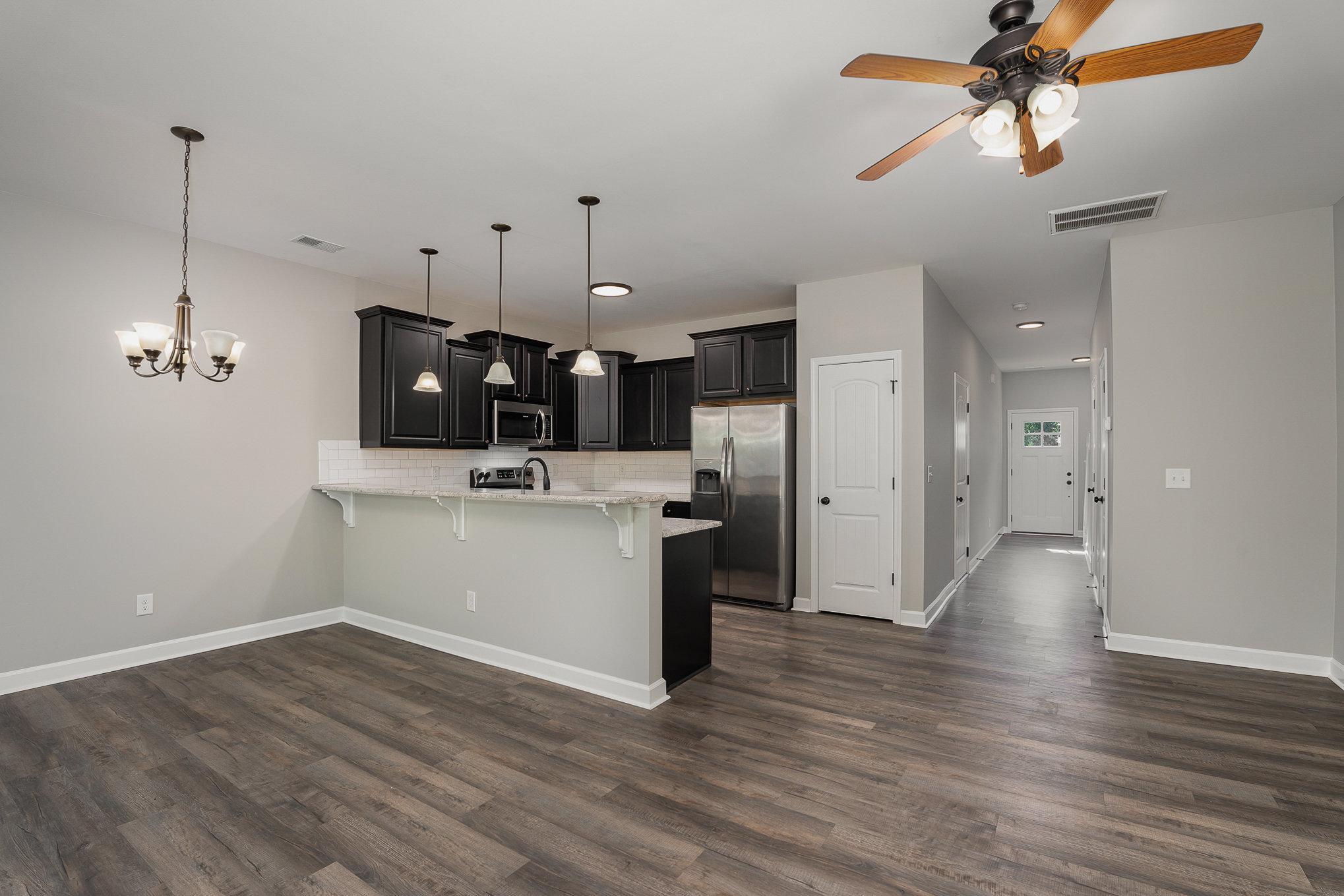 407 East 3rd Street Princeton, NC 27569 - Photo 5 of 18 a view of a kitchen with wooden floor