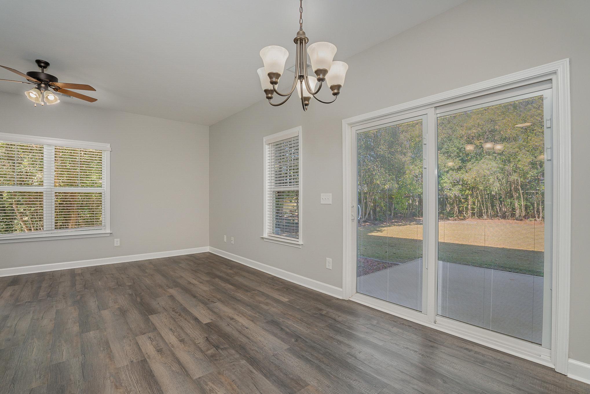 407 East 3rd Street Princeton, NC 27569 - Photo 6 of 18 a view of an empty room with wooden floor and a window