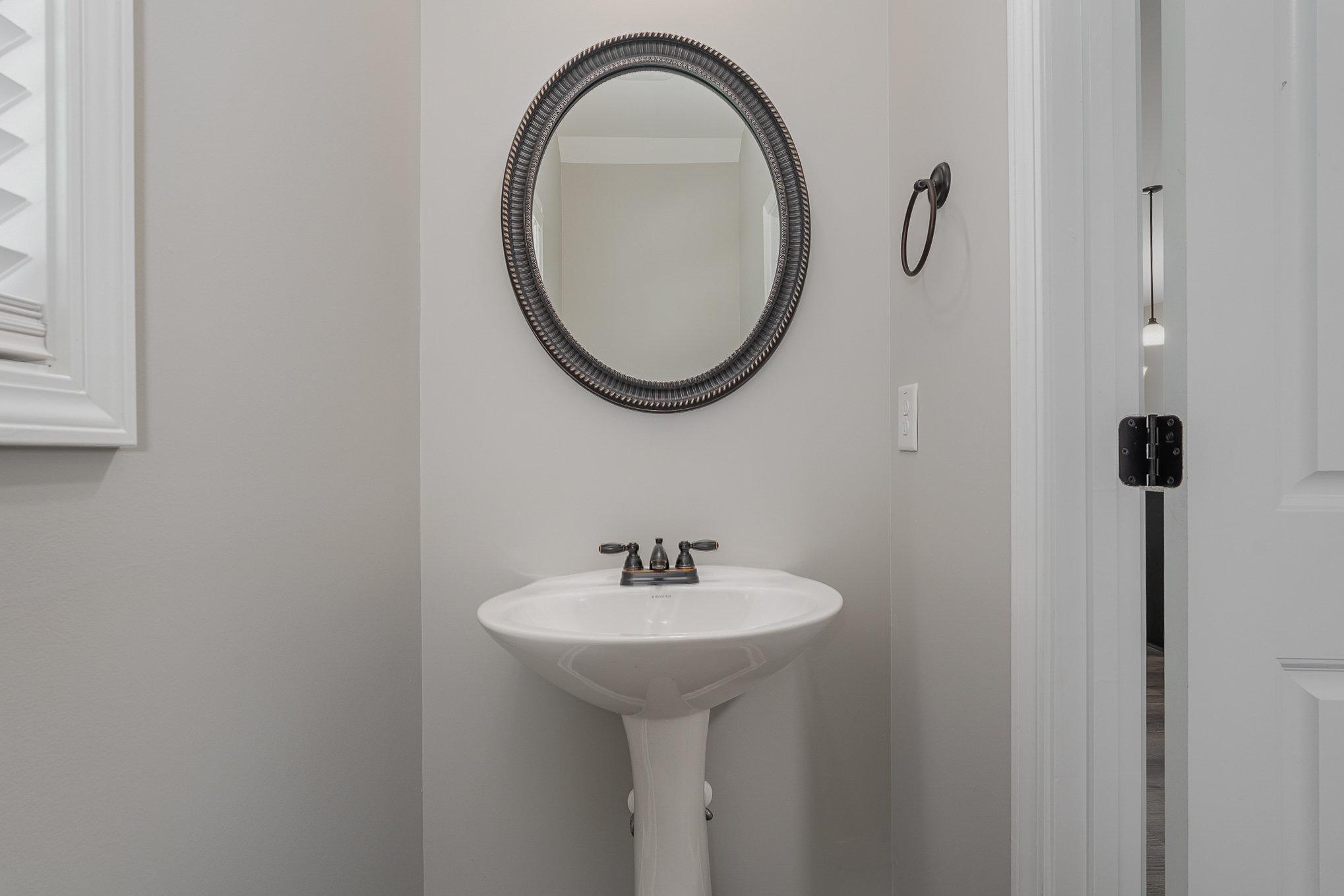 407 East 3rd Street Princeton, NC 27569 - Photo 7 of 18 a bathroom with a sink and a mirror