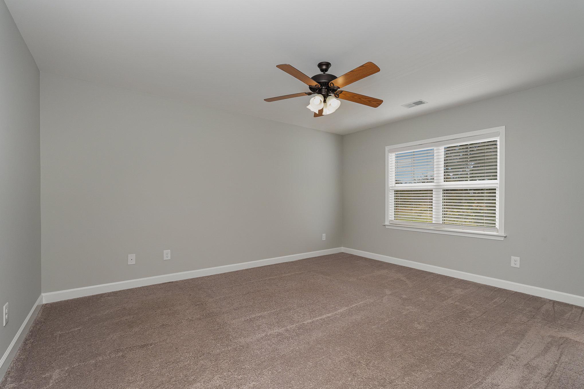 407 East 3rd Street Princeton, NC 27569 - Photo 8 of 18 a view of a livingroom with a ceiling fan and window
