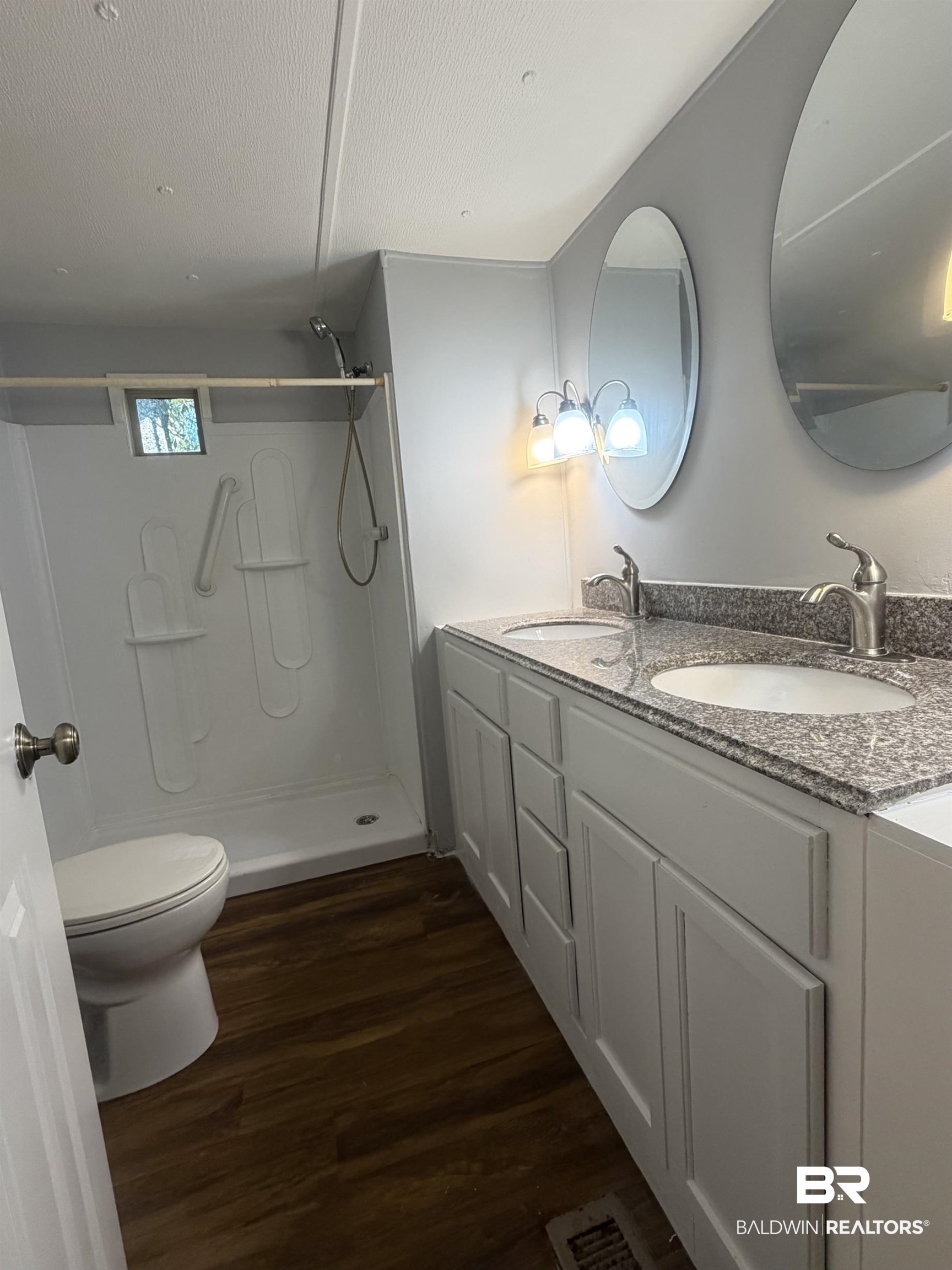 1354 Caney Loop Lillian, AL 36549 - Photo 20 of 45 Bathroom featuring a double vanity with granite-style countertops, dual undermount sinks, and brushed nickel fixtures