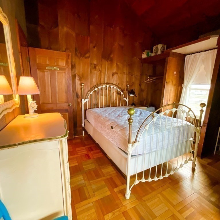 230 Manomet Point Road Plymouth, MA 02360 - Photo 12 of 15 a bedroom with a bed and a dresser