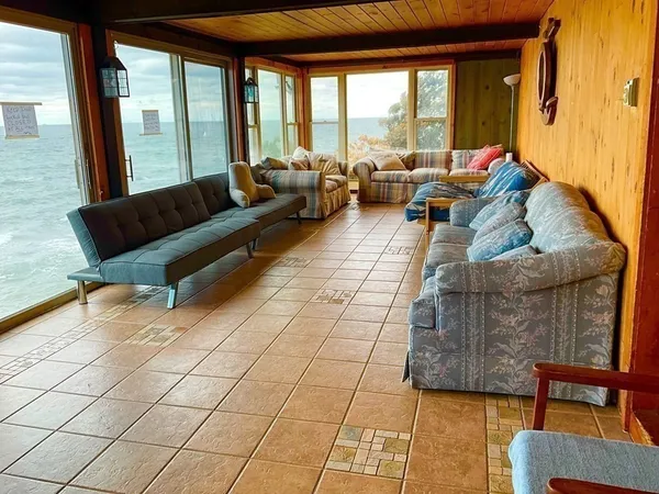 a living room with furniture and floor to ceiling windows