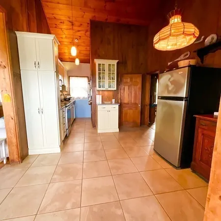 a kitchen with stainless steel appliances granite countertop a stove top oven and cabinets