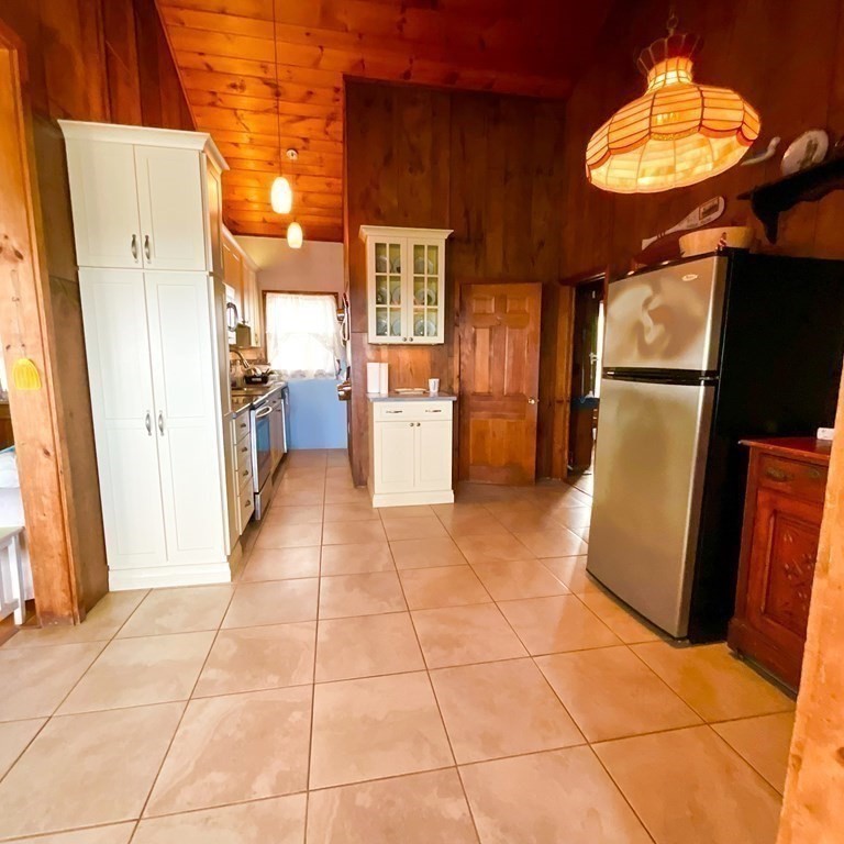 230 Manomet Point Road Plymouth, MA 02360 - Photo 7 of 15 a view of a refrigerator in kitchen and an empty room