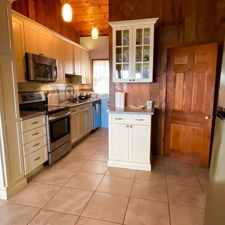 230 Manomet Point Road Plymouth, MA 02360 - Photo 8 of 15 a kitchen with stainless steel appliances granite countertop a stove top oven and cabinets