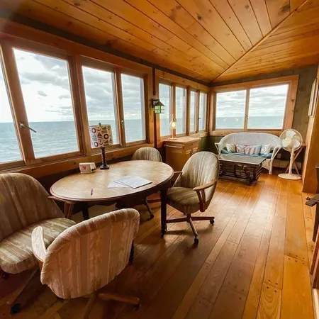 a living room with a couch wooden floor and a table